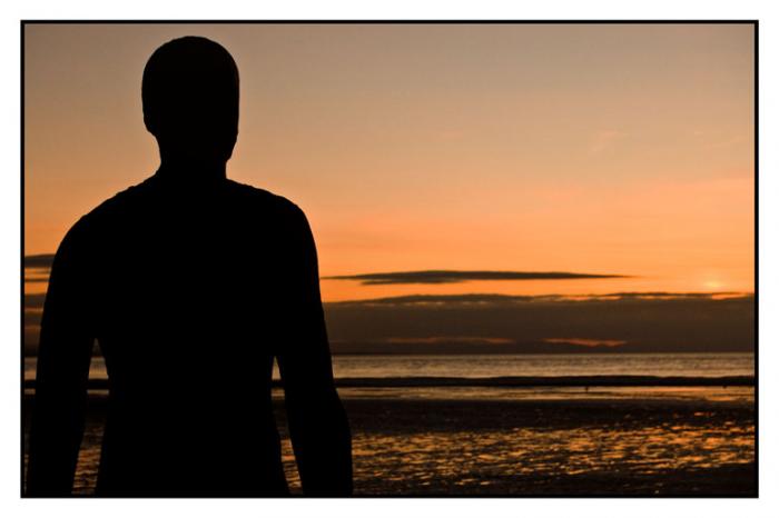 Iron man silhouette facing into the sunset, Another Place, Crosby Beach  
