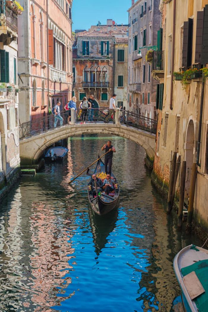 Gondola passing under a small bridge, Venice